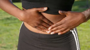 woman holding her stomach in pain